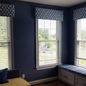 three windows with blue valances