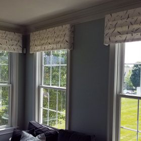three valances in a patterned white fabric